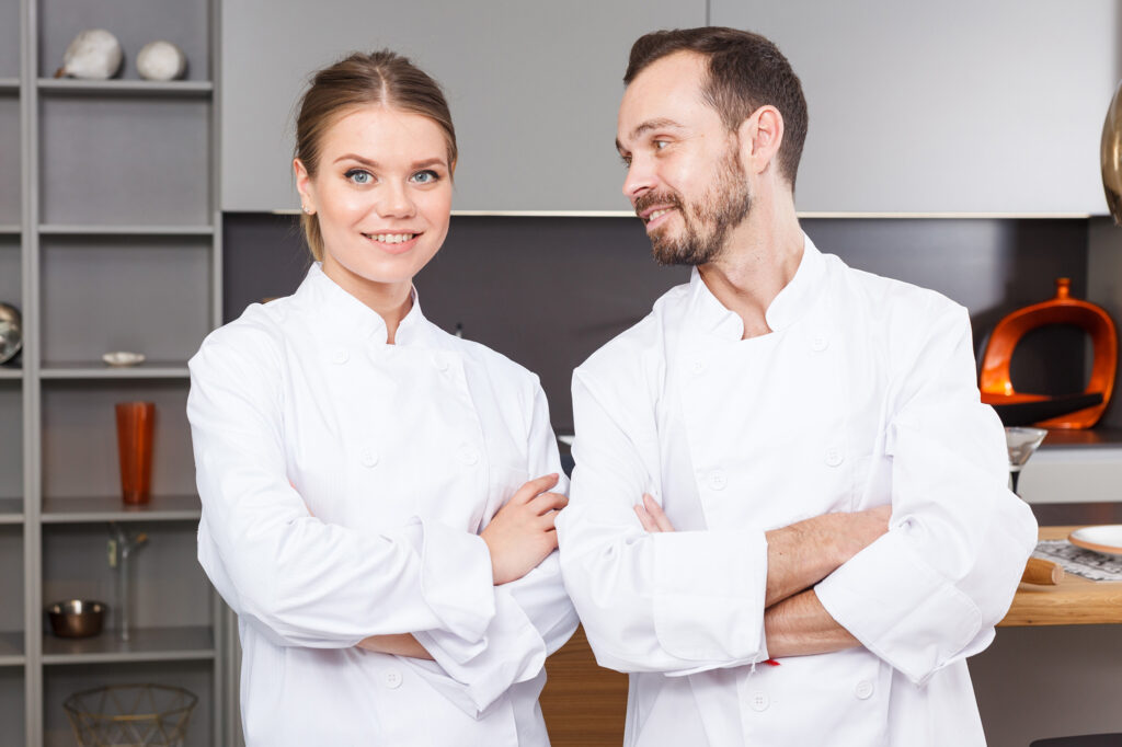 Domestic Couple Smiling In Private Household Kitchen