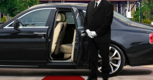 Private Security Chauffeur Standing Beside Rolls Royce